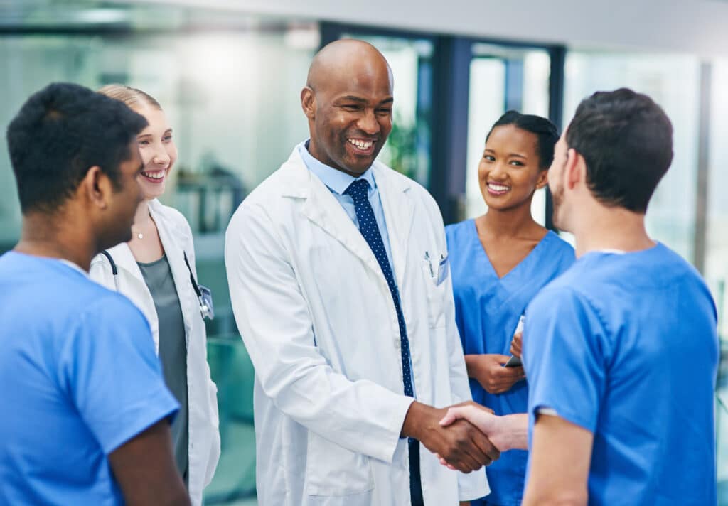 Shot of confident young doctors shaking hands in a modern hospital