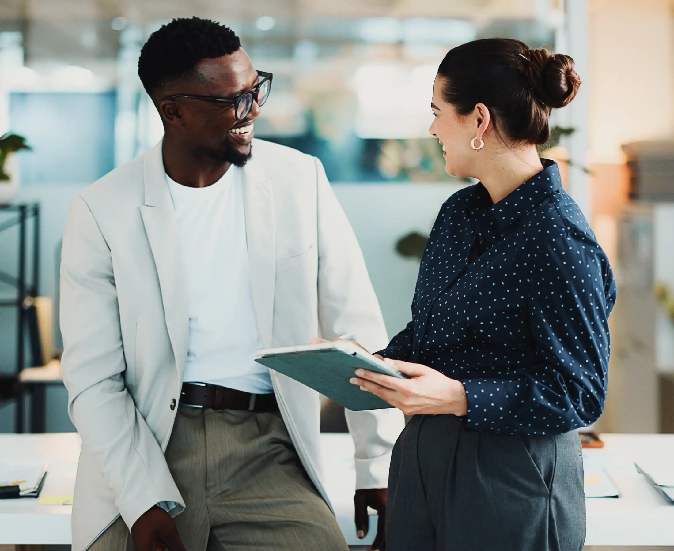 Happy people, meeting and talking in office with tablet